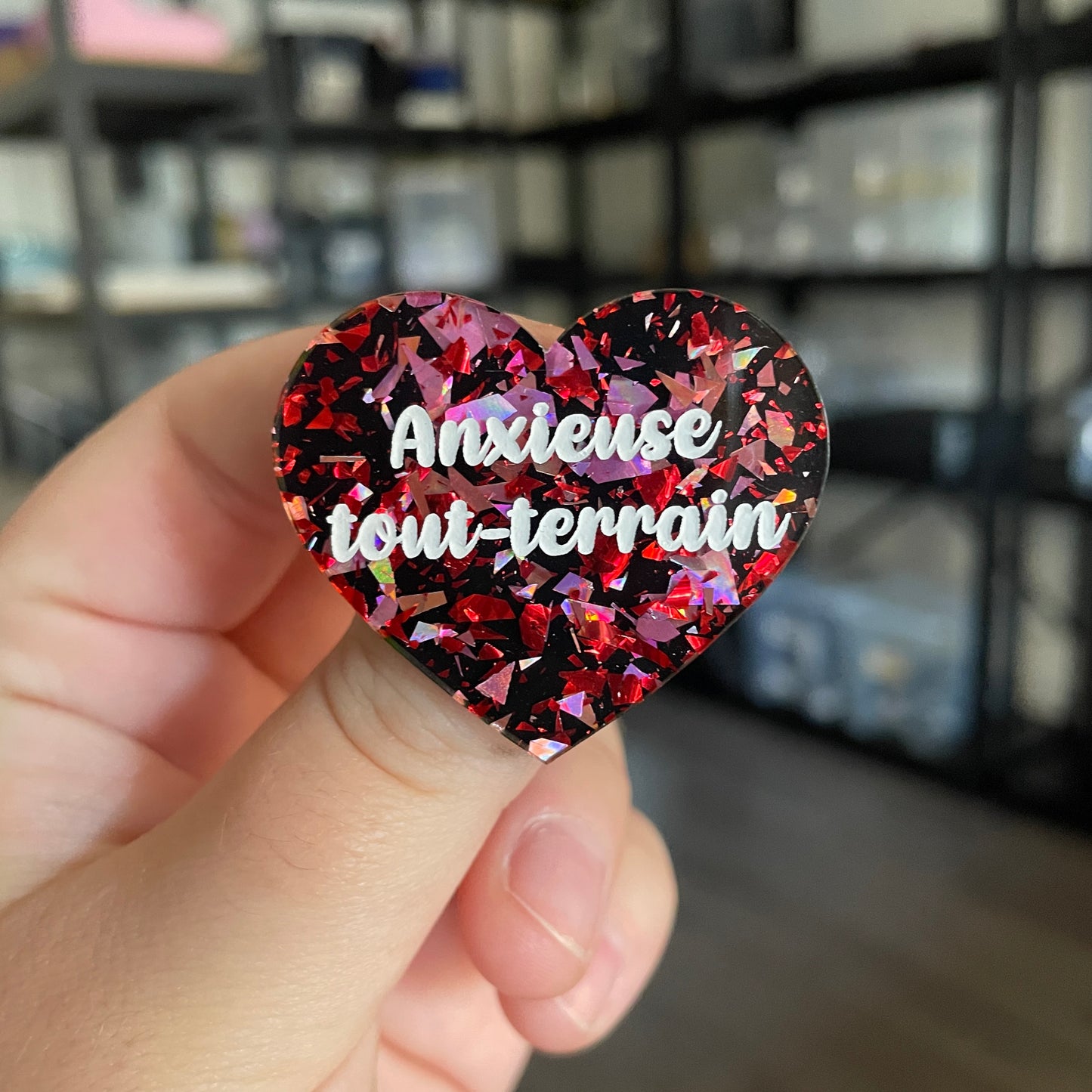 [CONTRÔLE TECHNIQUE] Broche "Anxieuse tout-terrain" en acrylique noire avec des éclats de confettis rouges et roses