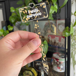 [CONTRÔLE TECHNIQUE] Pic à plante "I will survive" en acrylique transparente avec des confettis dorés