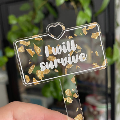 [CONTRÔLE TECHNIQUE] Pic à plante "I will survive" en acrylique transparente avec des confettis dorés