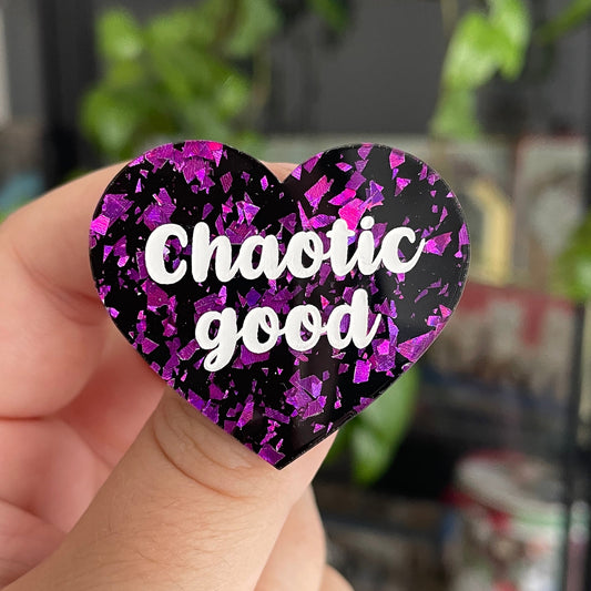 Broche "Chaotic good" en acrylique noire avec de éclats de confettis violets