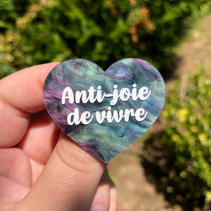 Broche "Anti joie de vivre" en acrylique marbrée vert, bleu, noir et rose