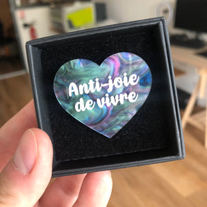 Broche "Anti joie de vivre" en acrylique marbrée vert, bleu, noir et rose
