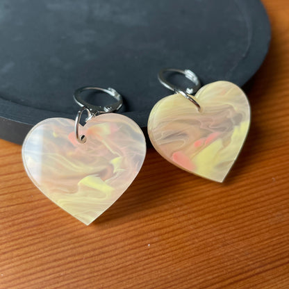 Petites boucles d'oreilles coeurs pendantes en acrylique marbrée orange/jaune