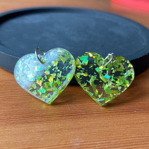 Petites boucles d'oreilles coeurs pendantes en acrylique transparente avec des éclats de confettis jaunes/verts