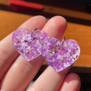 Petites boucles d'oreilles coeurs pendantes en acrylique avec des confettis étoiles, lunes et coeurs blancs et roses