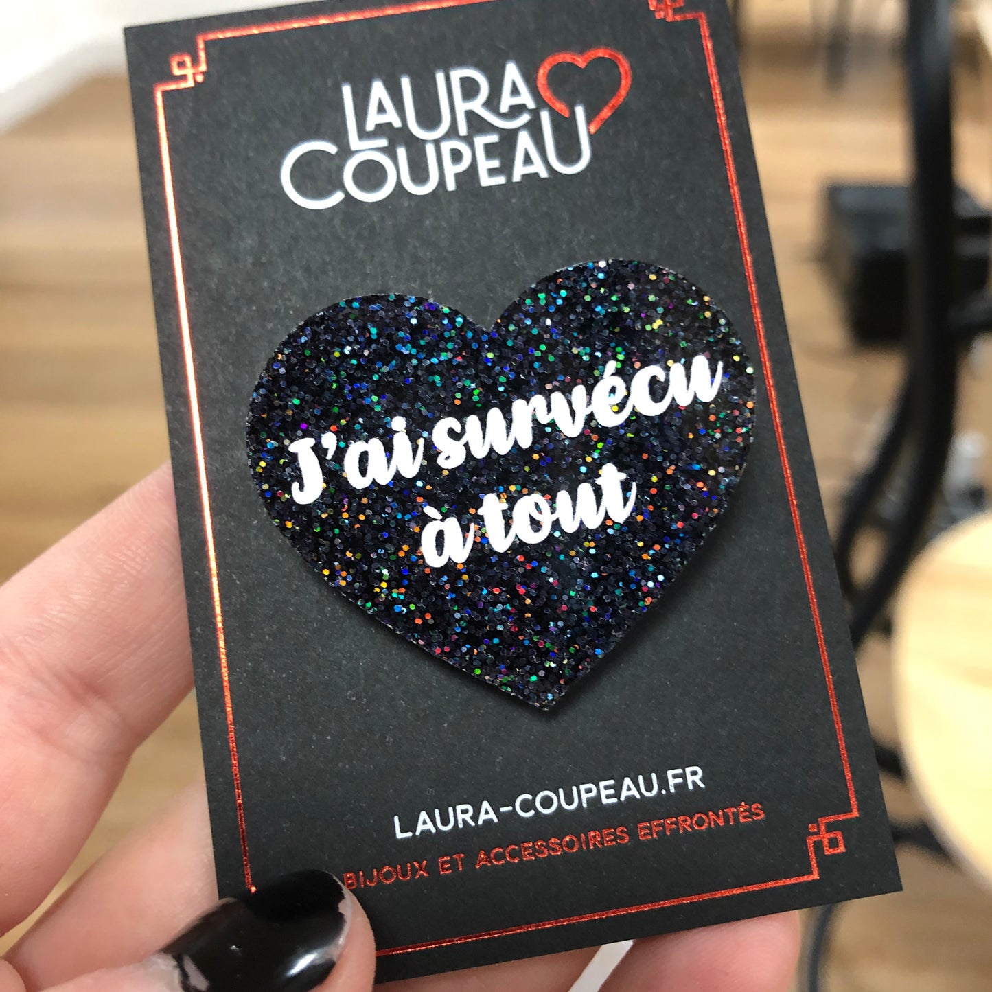 Broche "J'ai survécu à tout" en acrylique à paillettes noires holographiques