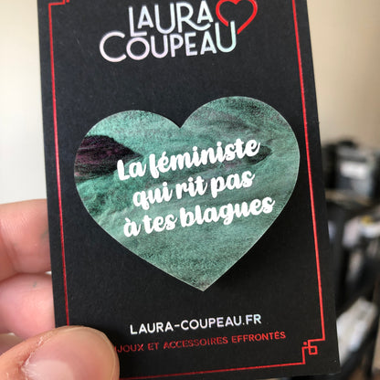 Broche "La féministe qui rit pas à tes blagues" en acrylique marbrée verte, noire et rose/violette